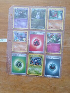 18 assorted Pokemon cards in sleeves